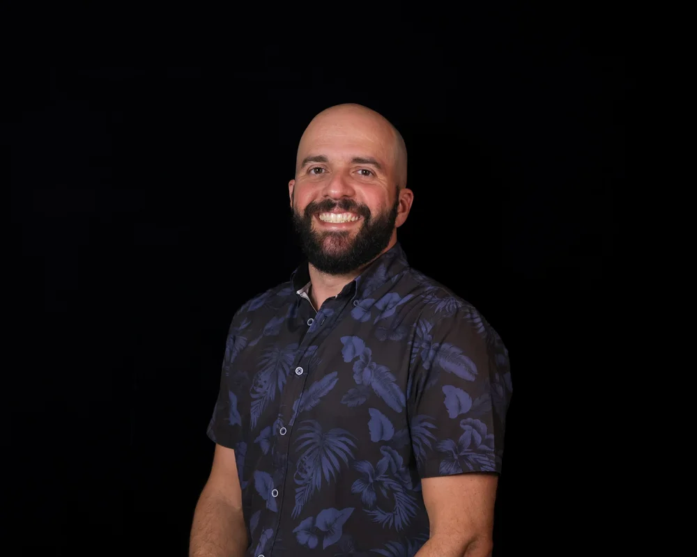 Portrait of Pastor Jacob Moreno smiling, wearing a navy Hawaiian shirt