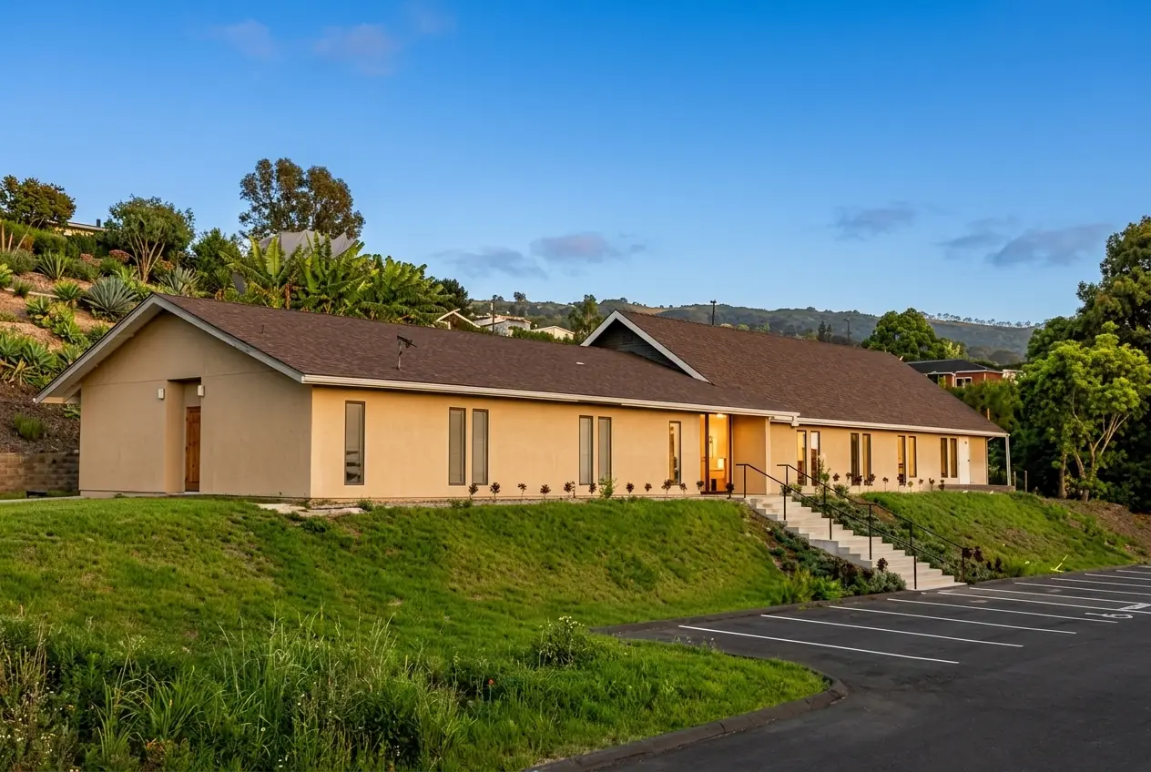 The Kona Seventh-day Adventist Church building on a green hillside under a clear blue sky